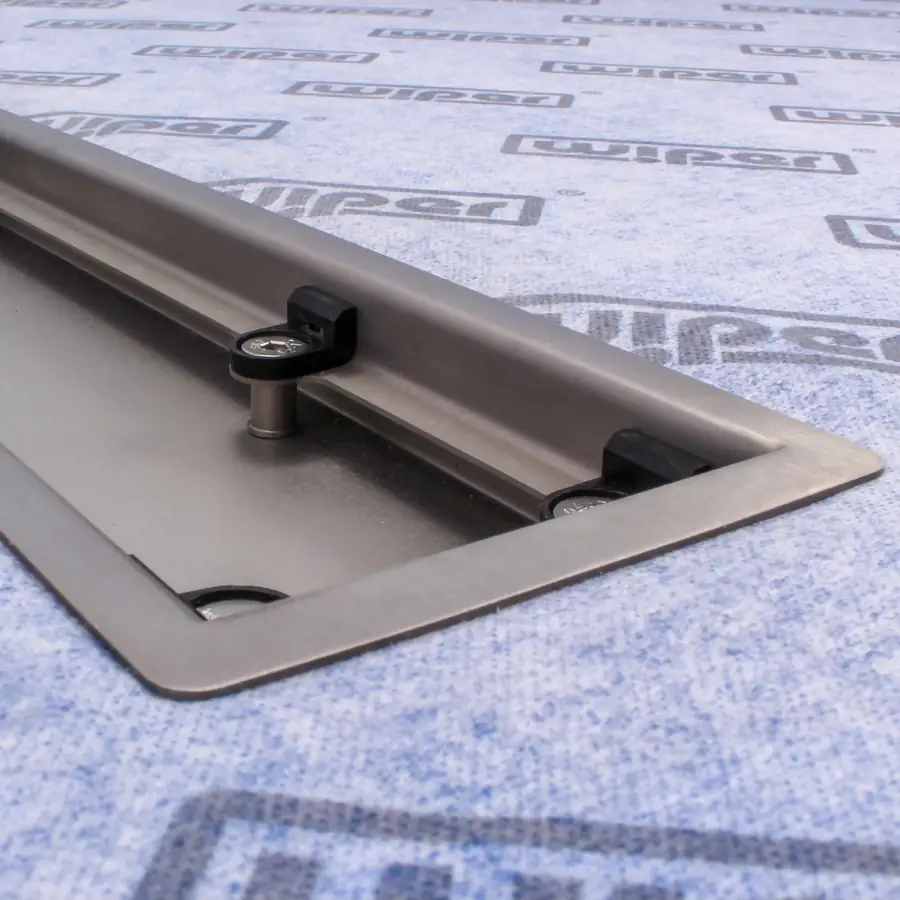 Close-up of the Wiper VF channel set in a Showerlay VF tray, showing the fixing posts and grating supports inside it